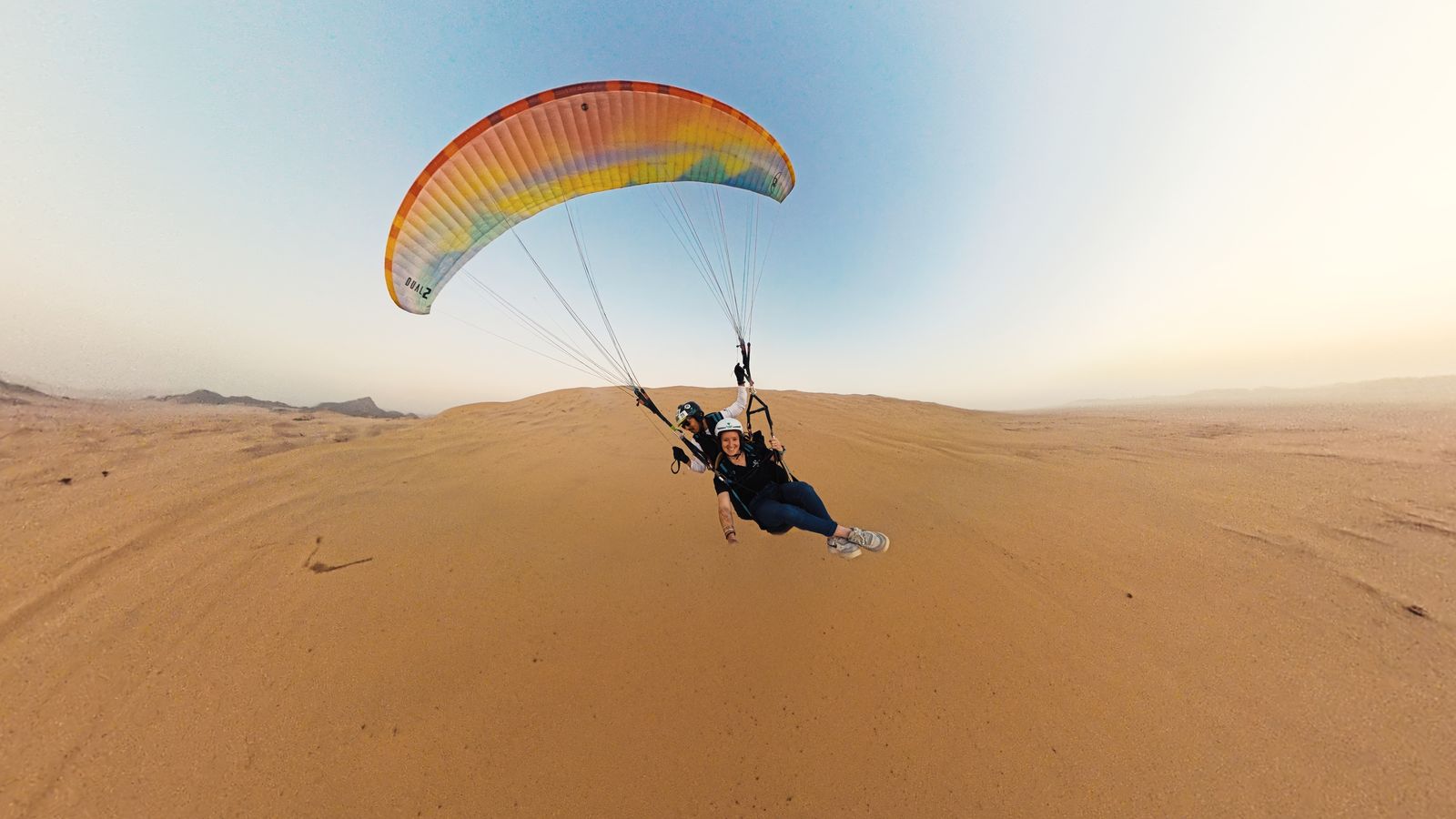 A paraglider sweeping over the dunes outside Yanbu at sunset